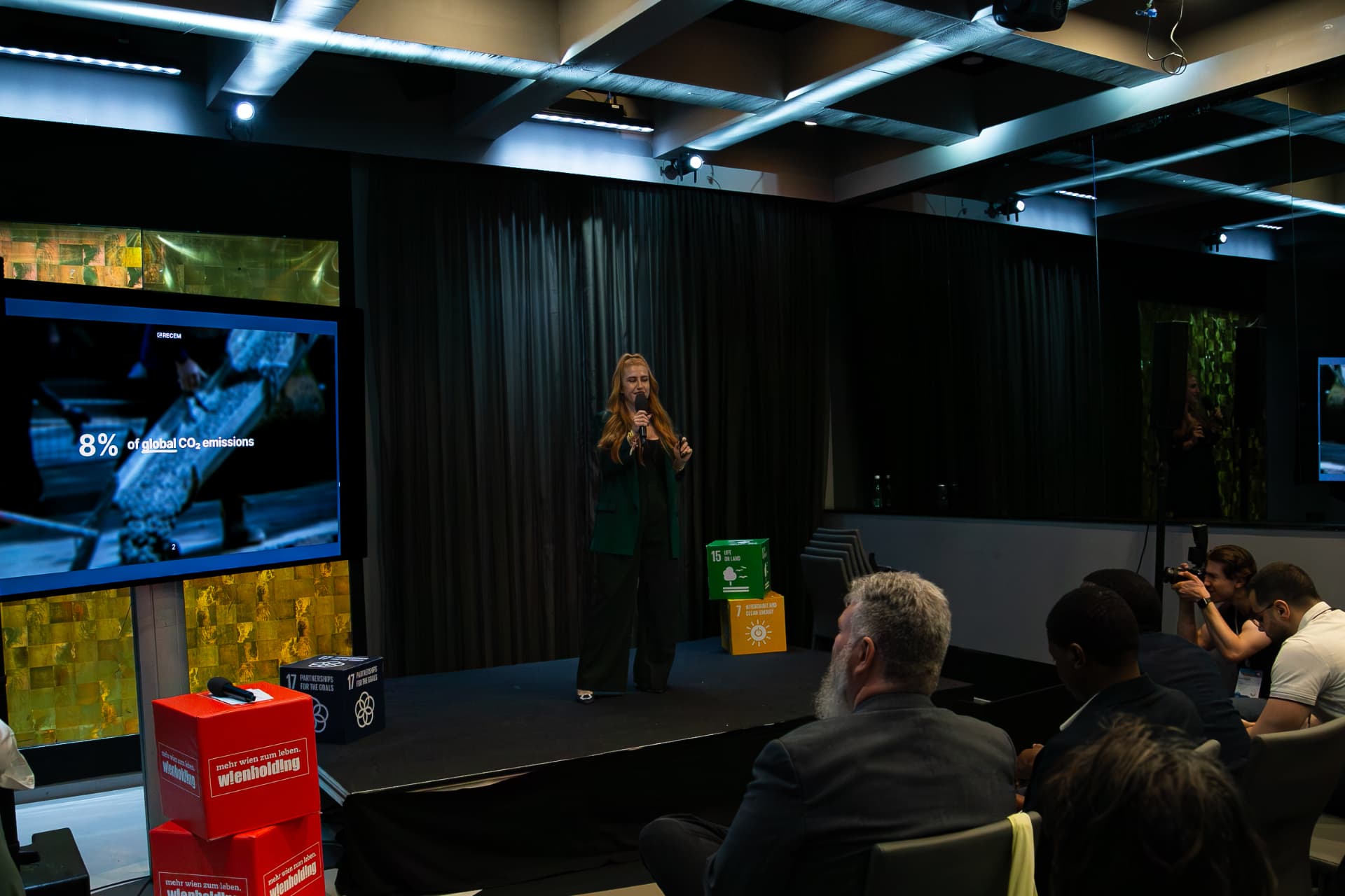 Eva-Maria Schneider pitching RECEM on stage in front of a jury and audience